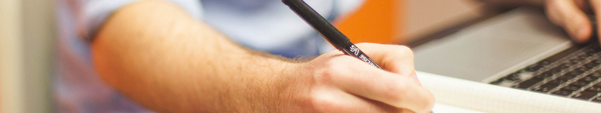 webinar banner image - writing next to laptop