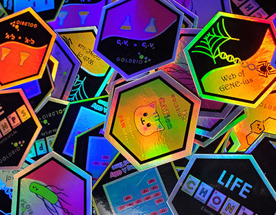 Pile of GoldBio collectible holographic stickers