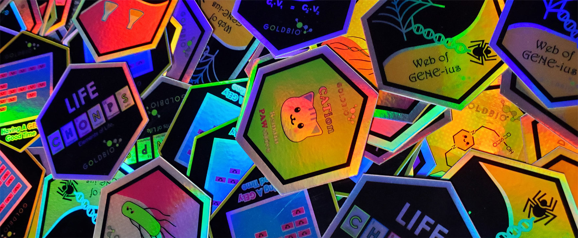 pile of goldbio holographic stickers Banner